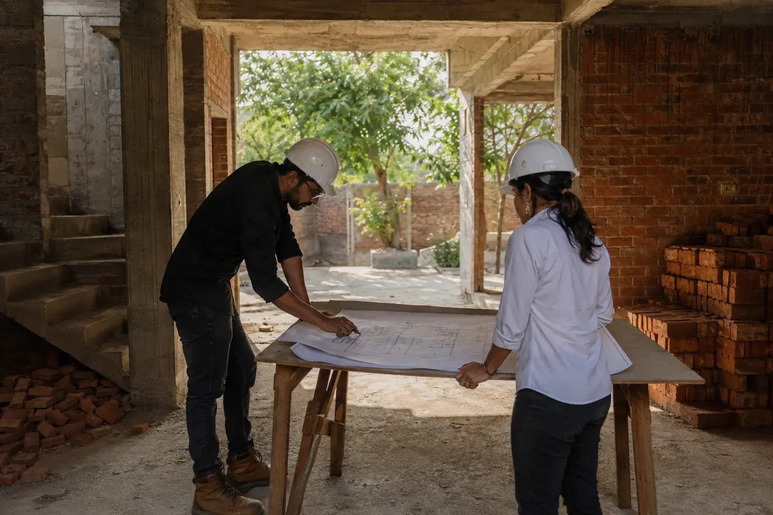 AI-generated construction study with two helmeted adults reviewing a drawing